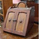An early 20th Century mahogany and elm log box, fitted with two doors,