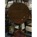 A George III Oak Tilt Top Table on Cabriole tripod supports.