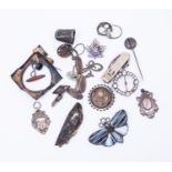 A collection of silver badges, brooches, cufflinks,