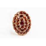 A 9ct gold and garnet oval cluster ring, size L, gross weight approx 5.