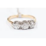 A diamond three-stone 18ct yellow gold ring, three round brilliant cut diamonds,