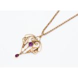 An Edwardian 9ct rose gold seed pearl and amethyst open work pendant,