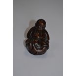 A treen netsuke of a sleeping man