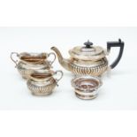 An Edwardian three piece silver bachelor tea set including teapot, sugar bowl and milk jug,