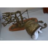 A wall mounted cast brass bell