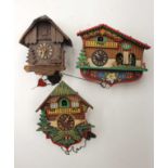 Collection of wall clocks including German cuckoo clocks,