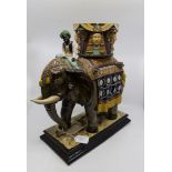 A Wilhelm Schiller & Sons Bohemia majolica elephant, standing on an oblong plinth base,