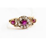 A Victorian ruby and diamond three stone ring, three rubies with diamond set borders rose gold,