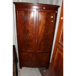 An Edwardian Mahogany bow fronted wardrobe,