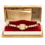 A 1950's 9ct gold ladies Roamer bracelet watch, shell motif detail to dial and strap, square dial,