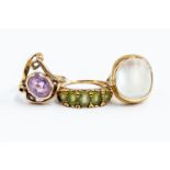 A collection of three gold rings including an amethyst and 9ct gold gold open work dress ring,