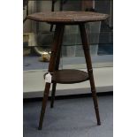 An Arts and Crafts mahogany tripod occasional table, with carved leaves, shells on the top,