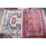 A pair of late 20th Century rugs, red ground, along with another 20th Century rug.