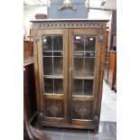 A mid 20th Century two glass fronted door cabinet