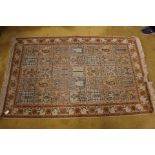 A 20th Century hand knotted woollen rug, decorated with flowering foliage in panels,
