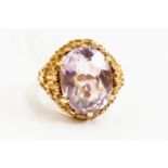 An amethyst and 9ct gold dress ring, oval stone, bark effect mount, 9ct gold, size N,