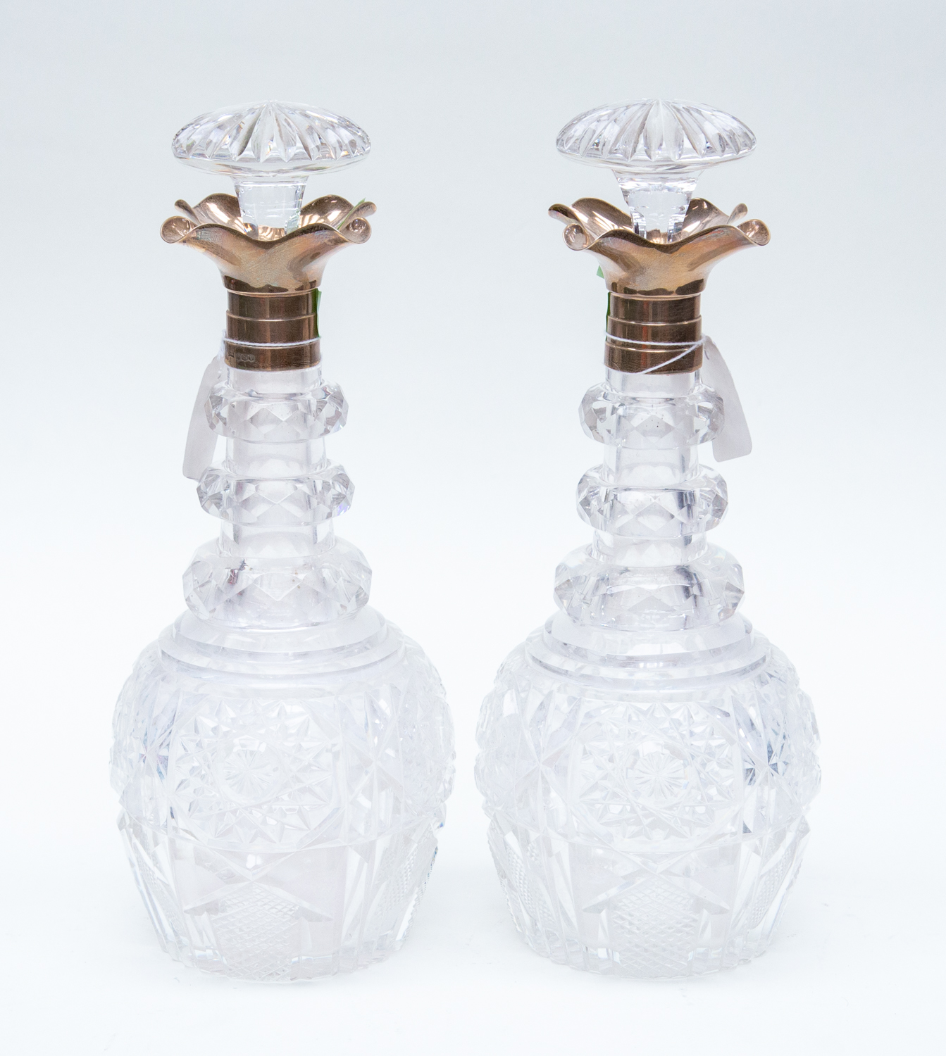 A pair of George VI hob nail cut glass baluster shaped decanters and stoppers,