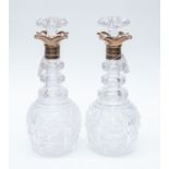 A pair of George VI hob nail cut glass baluster shaped decanters and stoppers,