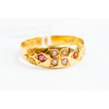 A Victorian ruby and seed pearl ring, scroll decoration, 18ct gold, size R,