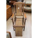 An early 20th Century beech framed folding steamer chair, retaining original cane work back,