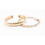 Two 9ct gold bangles, comprising one hinged version and a torque bangle,