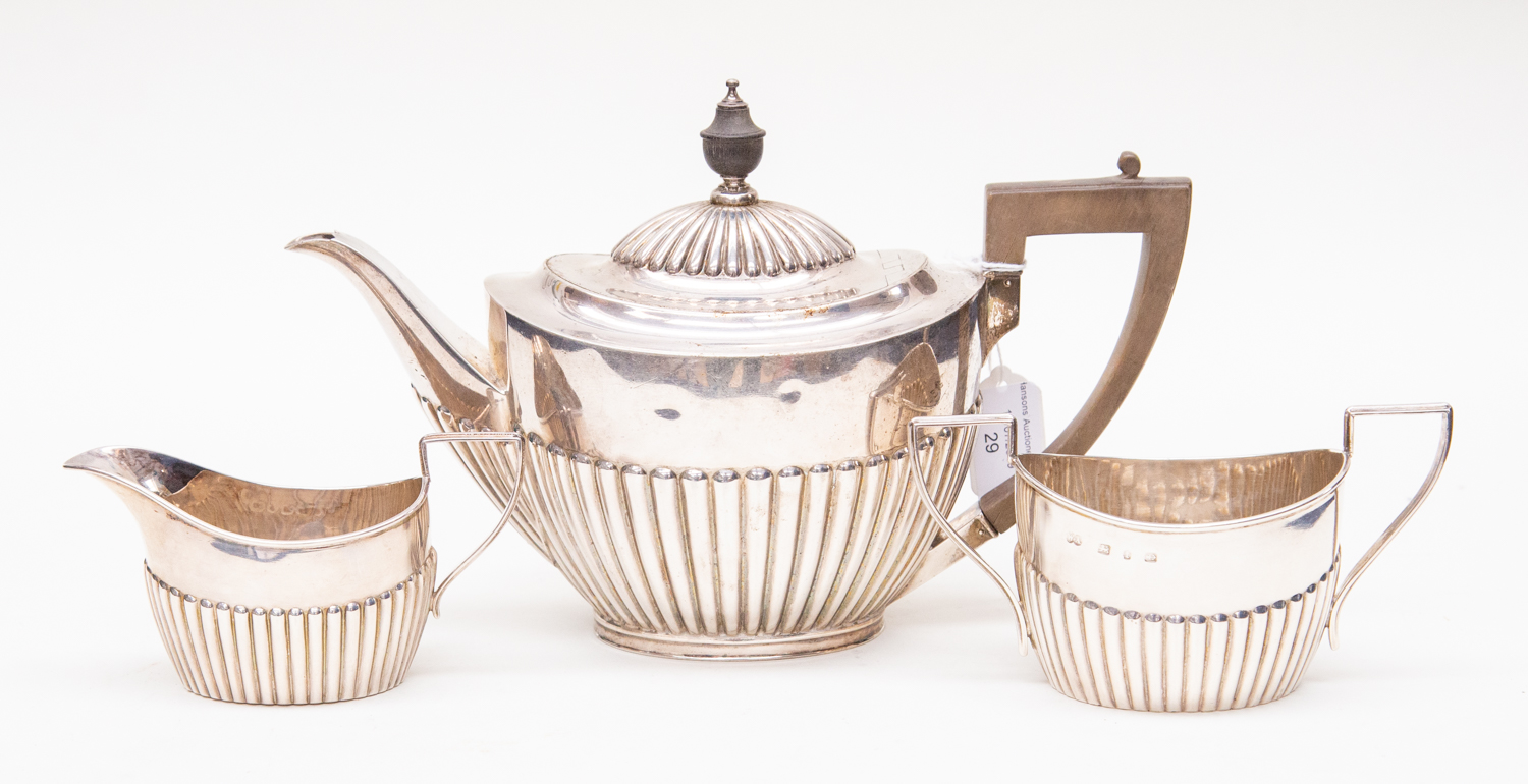 A Victorian silver oval semi fluted teapot and sugar and milk (different hallmarks)