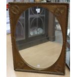 Oval mirror in a rectangular gilt frame