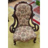A Victorian walnut carved armchair, scroll arms, cabriole feet,