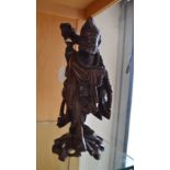 An Oriental carved wooden figure 35cm in height.