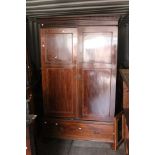 A late 19th Century Mahogany Wardrobe on Chest.