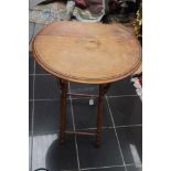 A small fold down tea table with bamboo style legs