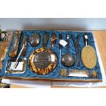 A cased Chinese tortoiseshell dressing set, with dragon motifs,