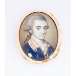 A George III oval portrait miniature of a young dandy, wearing white stock and a blue tunic,