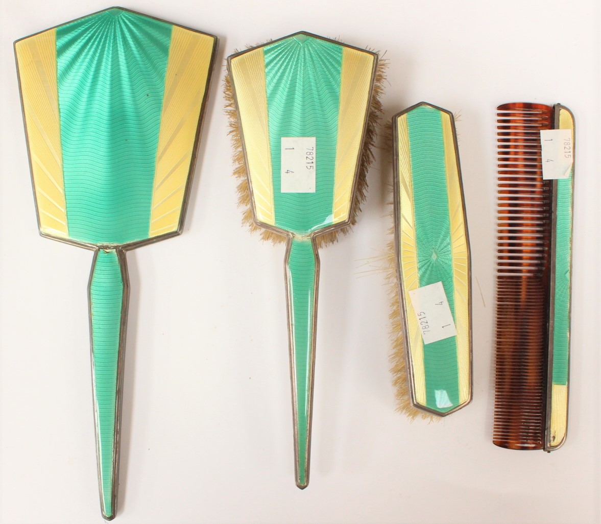 An Art Deco four piece silver and enamel brush set (s,