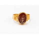 A Roman Empire 2nd/3rd Century AD carnelian intaglio ring, depicting a Roman Deity,