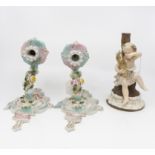 A large Chelsea style porcelain candelabra with cherubs in Meissen style, blue anchor mark to base,
