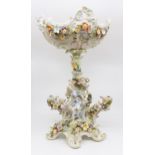A pair of vases, comport, centrepieces and a comport base, all decorated with encrusted flowers,