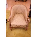 A cream upholstered tub armchair