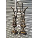 Two tall Middle Eastern design metal jugs