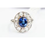 A diamond and sapphire cluster ring, central set oval sapphire approx 5mm x 8mm,