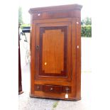 A George III oak and mahogany cross-banded hanging corner cupboard,