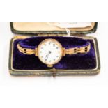 A 1930's 9ct gold ladies wristwatch, enamel dial engraved back, patterned expander bracelet,