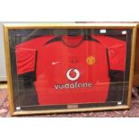 A signed, framed and glazed Manchester United home shirt, Rio Ferdinand,