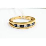 A sapphire and diamond half eternity ring, channel set with seven stones, size N, 18ct gold,