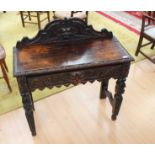 A Victorian oak carved hall table with drawer