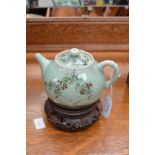 Chinese pale green glazed teapot on wooden stand A/F