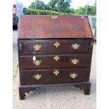 A George II oak bureau, circa 1750, the fall opening to reveal a fitted interior,