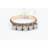 An 18ct gold ring, set with five diamonds weighing approx half a ct,