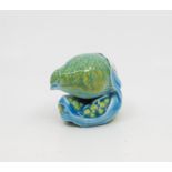 A Royal Worcester netsuke modelled as a quail, heightened in blue and green,
