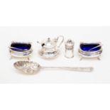 A collection of silver comprising a heavily decorated spoon, mustard pot,